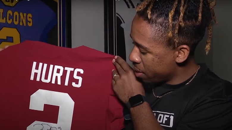 Averion Hurts Jr holds up one of his brother's jerseys