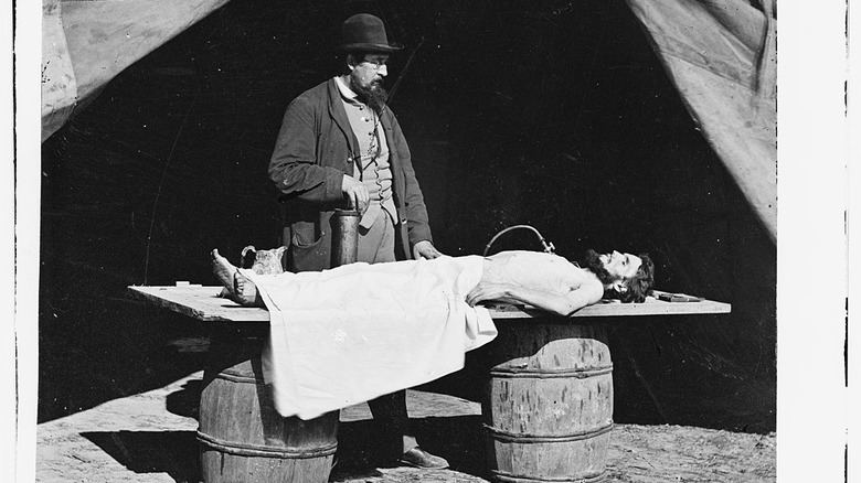 Surgeon embalming soldier in Civil War