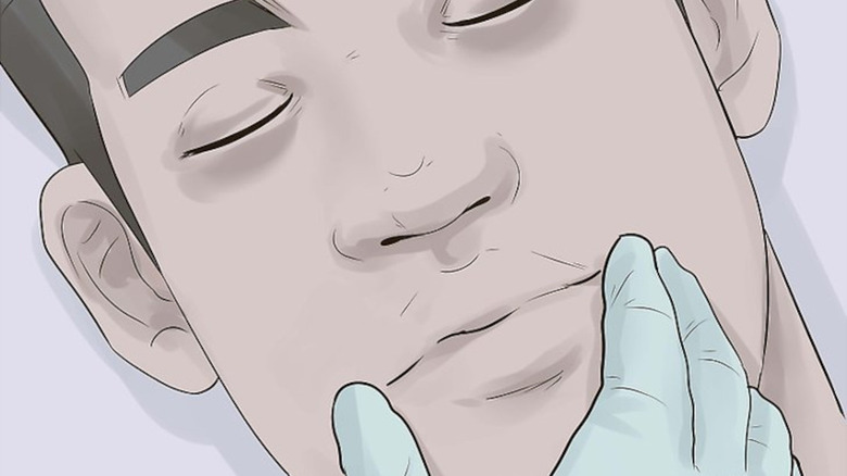 Illustration of embalmer setting the features