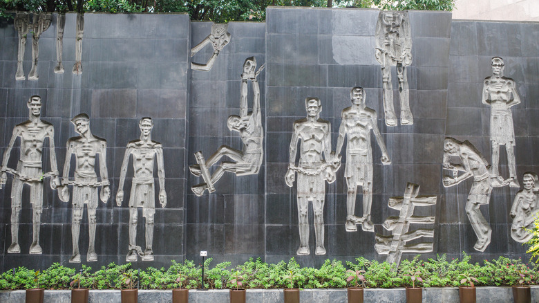 relief mural of torture at hanoi hilton