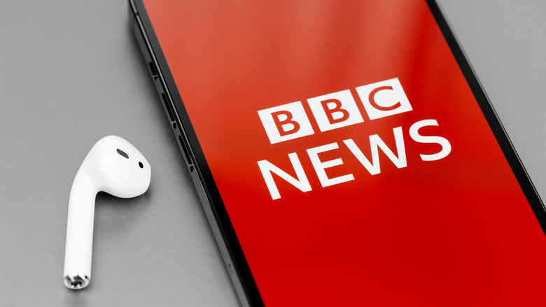 Headphone and phone with BBC News logo