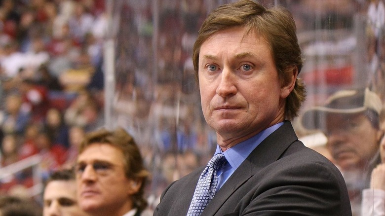 Head Coach Wayne Gretzky of the Phoenix Coyotes manages his team from behind the bench during his game in 2009