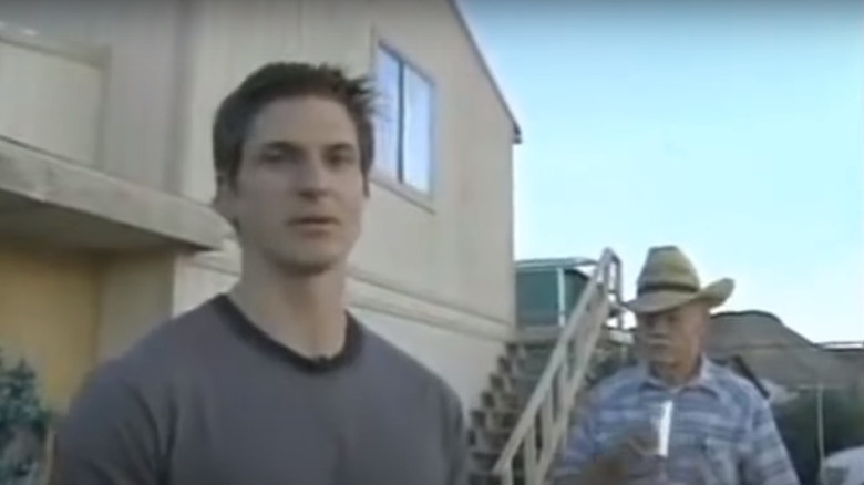 Zak Bagans standing in front of house