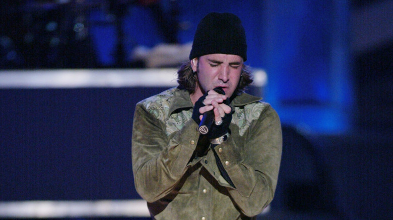 Creed's Scott Stapp wearing a beanie and singing at the Salt Lake Winter Olympics in 2002