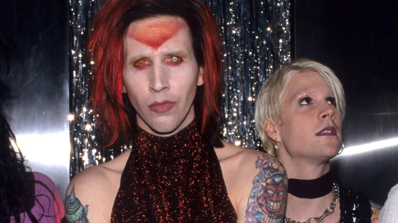 marilyn manson red hair stands by john 5 looking off in late 1990s