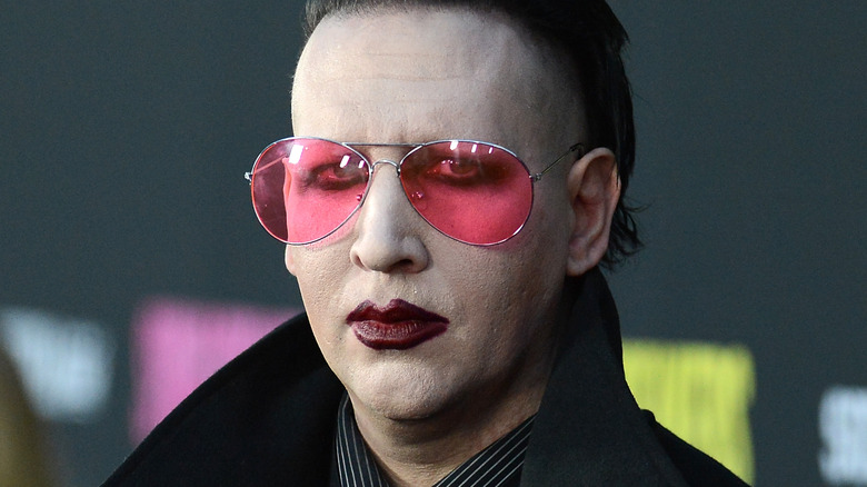 marilyn manson in sunglasses and scowling like he's sick in 2013