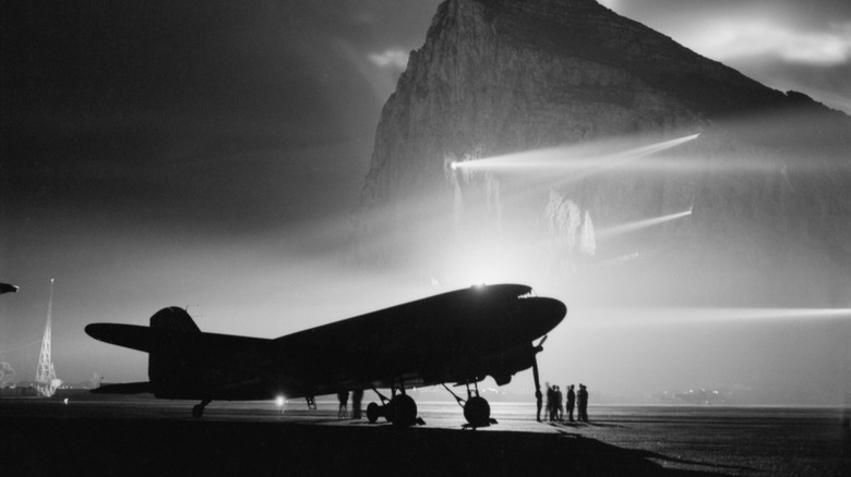 Douglas DC-3 against Rock of Gibraltar, silhouetted by searchlights, 1940 to 1945.