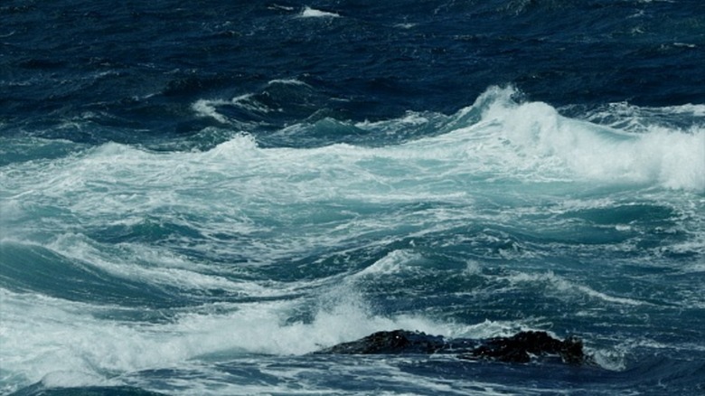 Blue waves in ocean closeup.