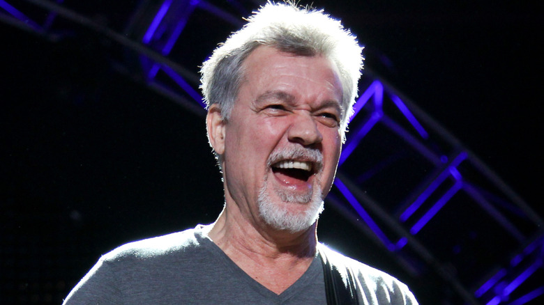 eddie van halen smiling while playing onstage