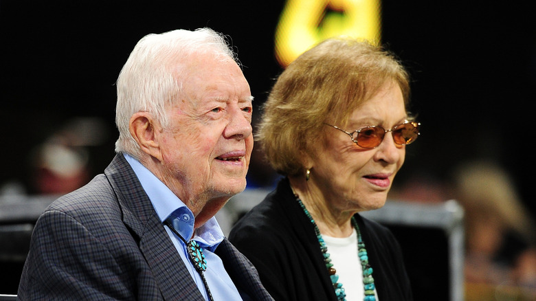 An elderly Jimmy and Rosalynn Carter sitting next to each other