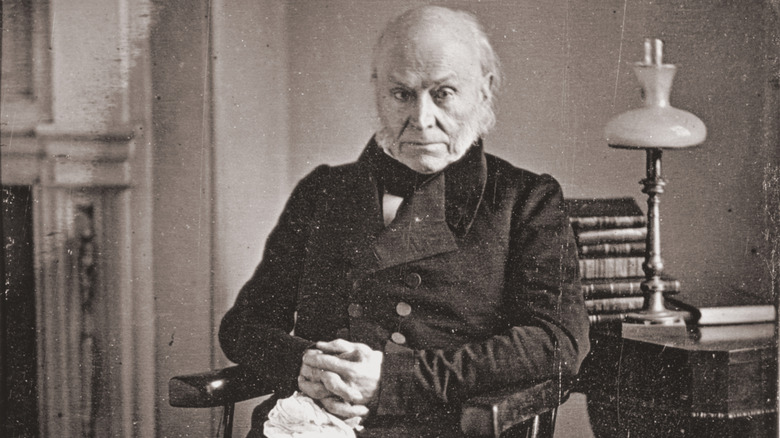 John Quincy Adams in old age, sitting by a desk