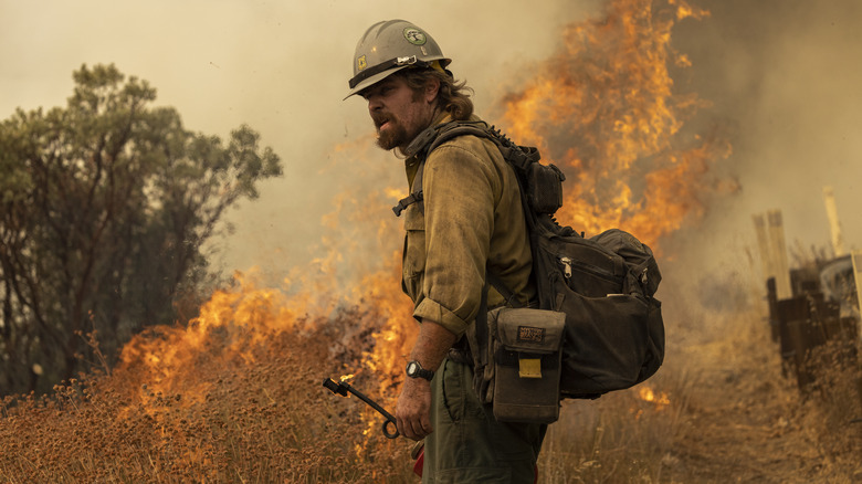 firefighter in the middle of a wildfire