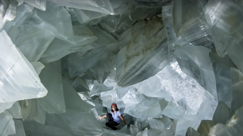 Geologist Mila Carretero sitting inside the huge Pulpí geode