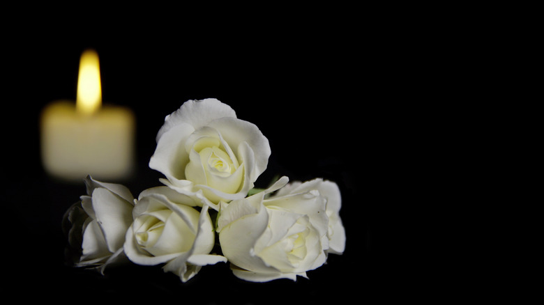 candle and flowers at funeral