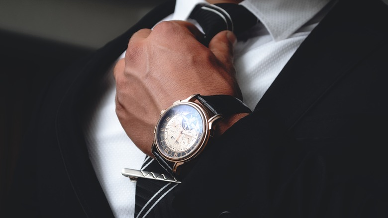 man wearing suit and wristwatch 