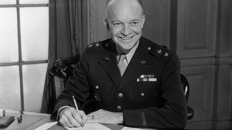 Dwight D Eisenhower uniform signing document smiling