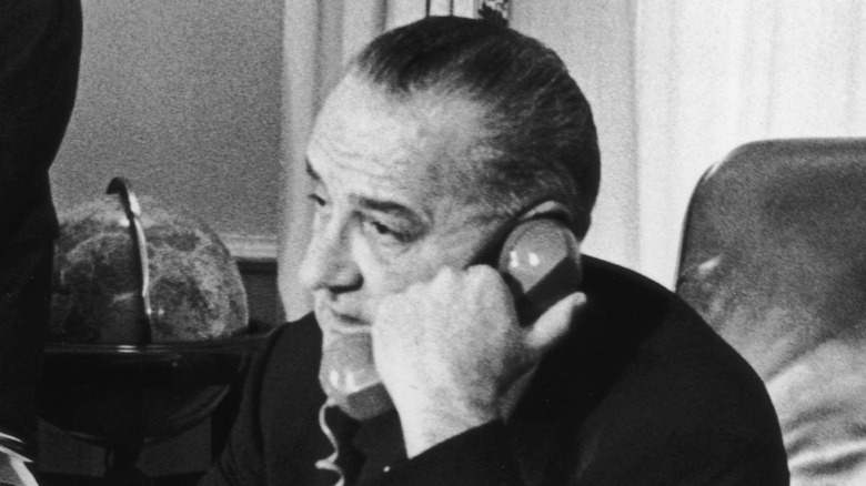 Lyndon B Johnson in office talking on phone