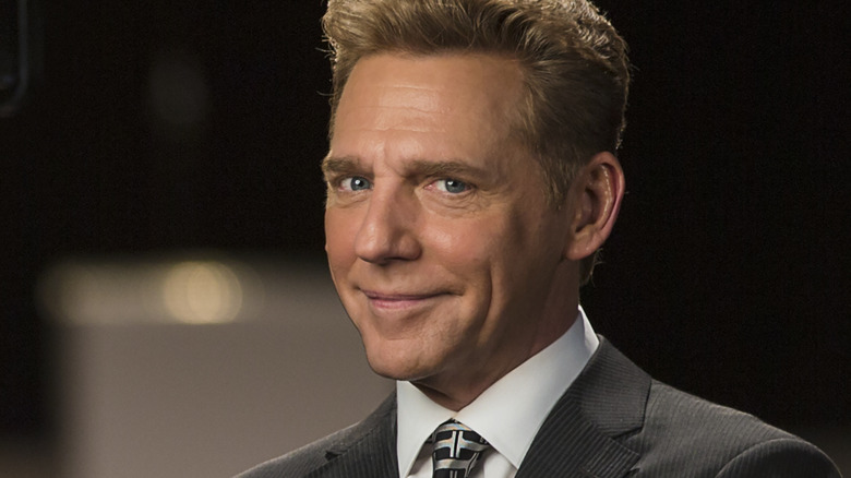 David Miscavige smiling portrait photo dark background