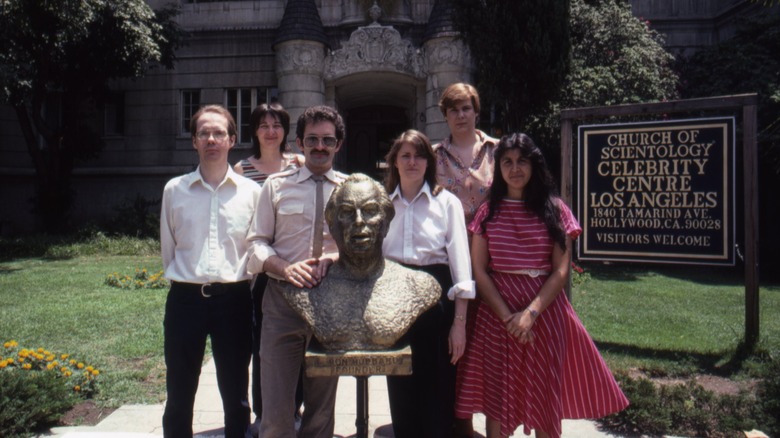 bust of L. Ron Hubbard outside scientology center with people