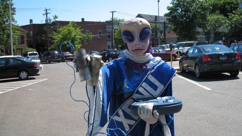 Person dressed up as "Xenu" holding an e-meter