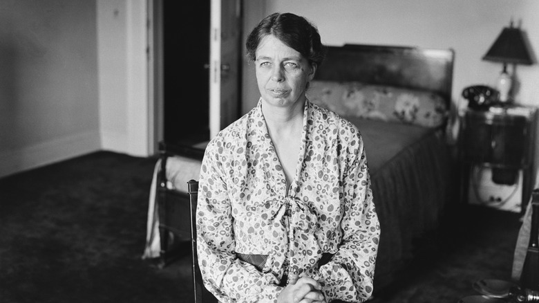 Eleanor Roosevelt sitting in a simple bedroom