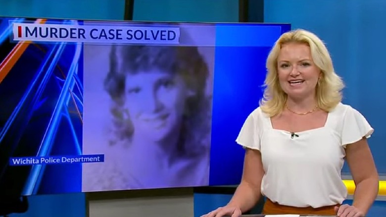 A news anchor with a graphic on case in the background