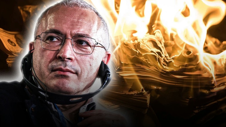 Mikhail Khodorkovsky infront of burning cash money