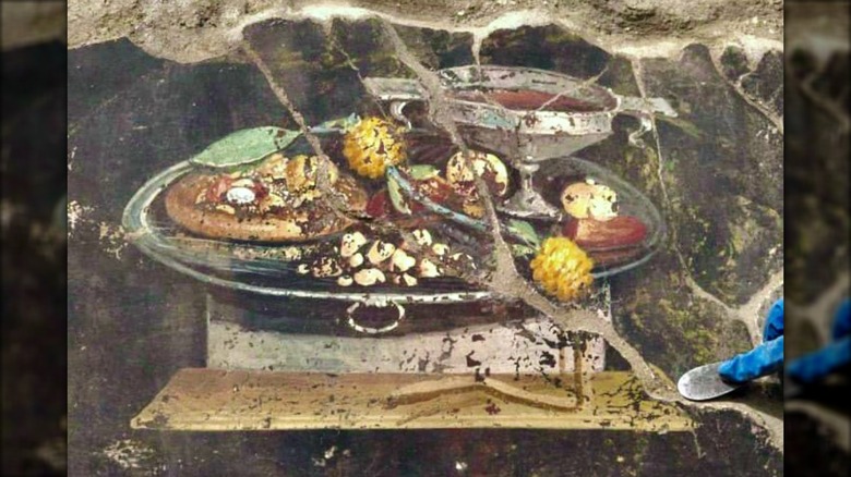 Mural of food in Pompeii including pizza