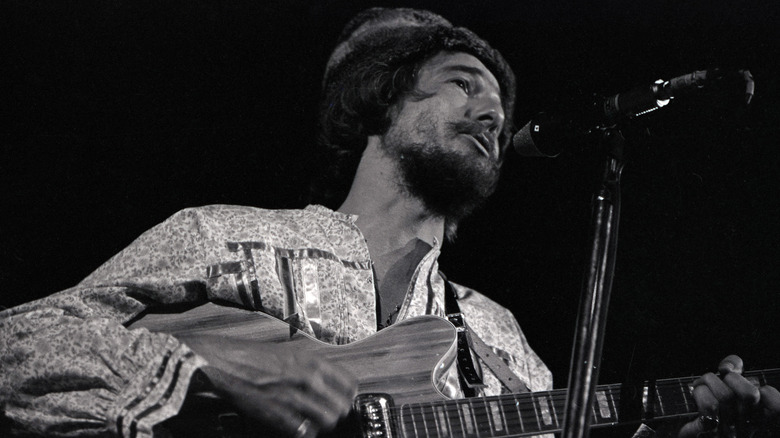 John Phillips plays guitar