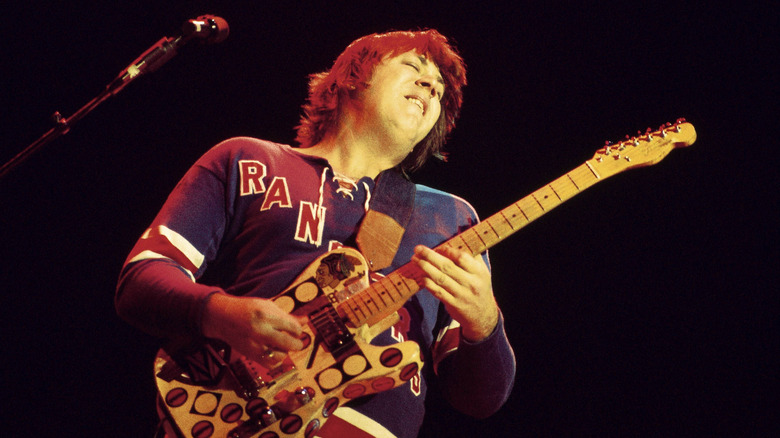 Terry Kath shredding a guitar on stage