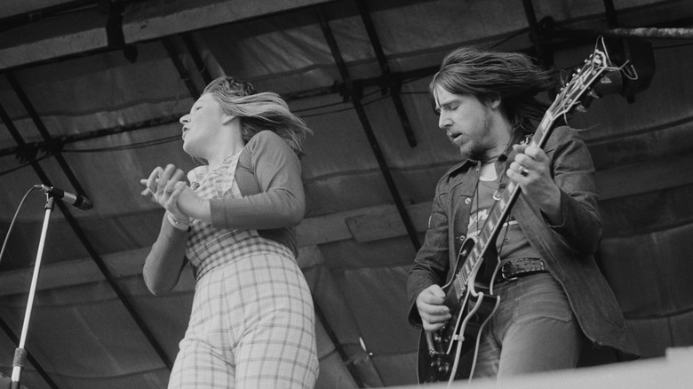 Les Harvey playing guitar on stage