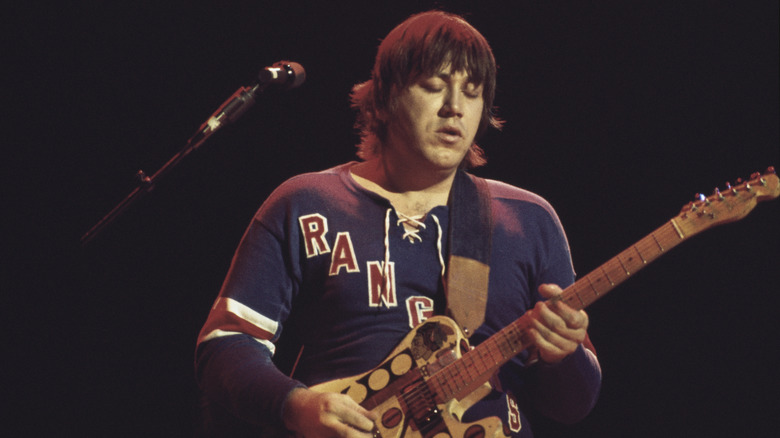 Terry Kath playing guitar in a Rangers jersey