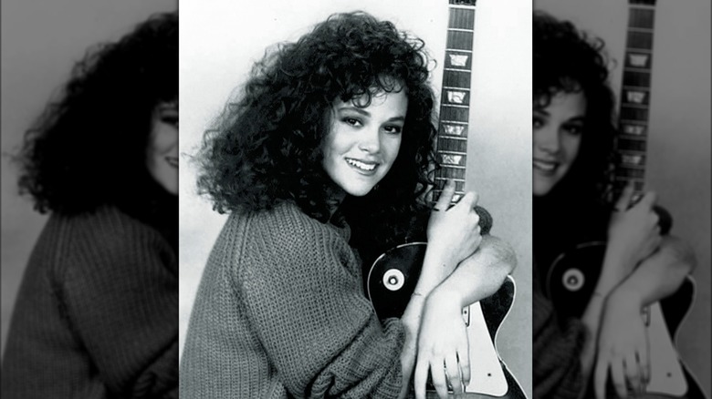 Rebecca Schaeffer holding guitar