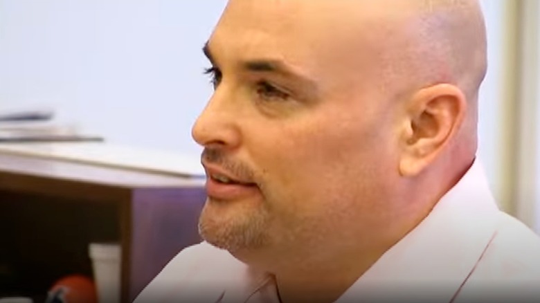 Eric Naposki sits at table at sentencing hearing