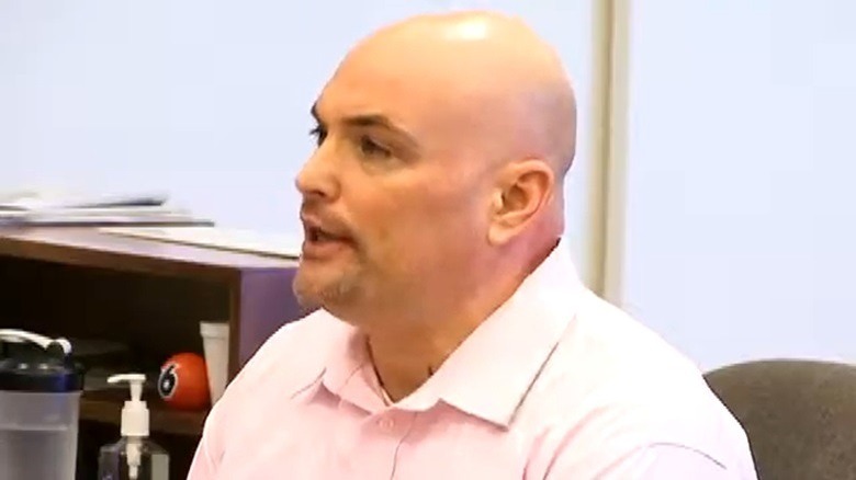 Eric Naposki white shirt bald speaking