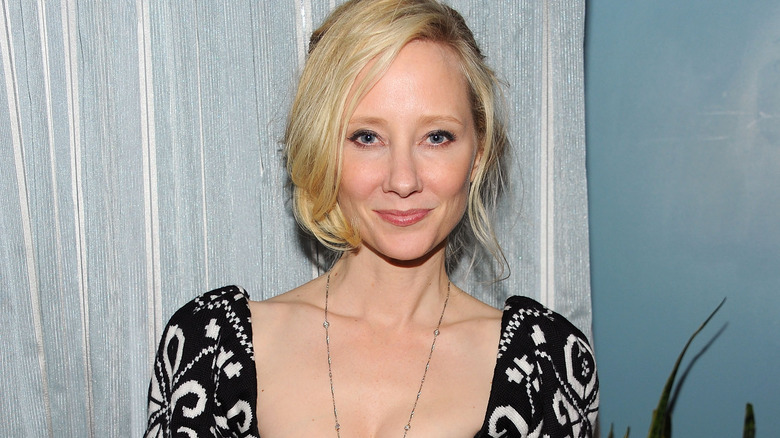 Anne Heche smiling dress by curtain