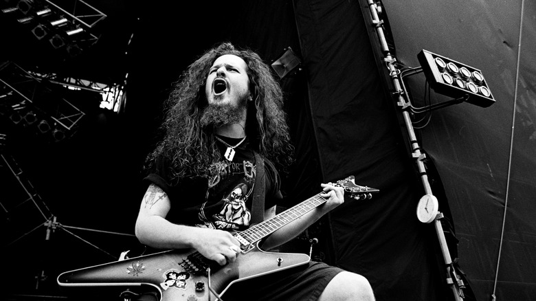 Dimebag Darrell playing guitar in black and white