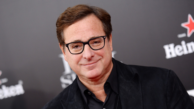 Bob Saget glasses black shirt on a red carpet