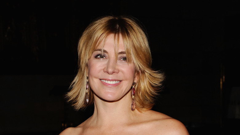 Natasha Richardson smiling blond hair dark background