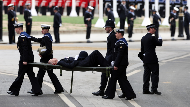 Official faints and queen's funeral