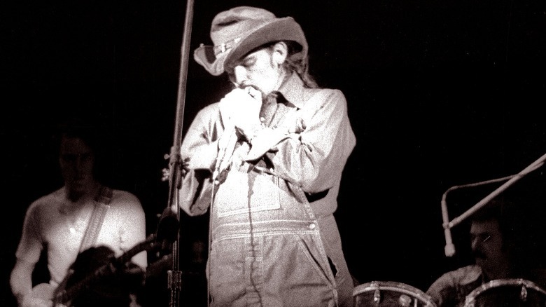 Pigpen playing harmonica onstage