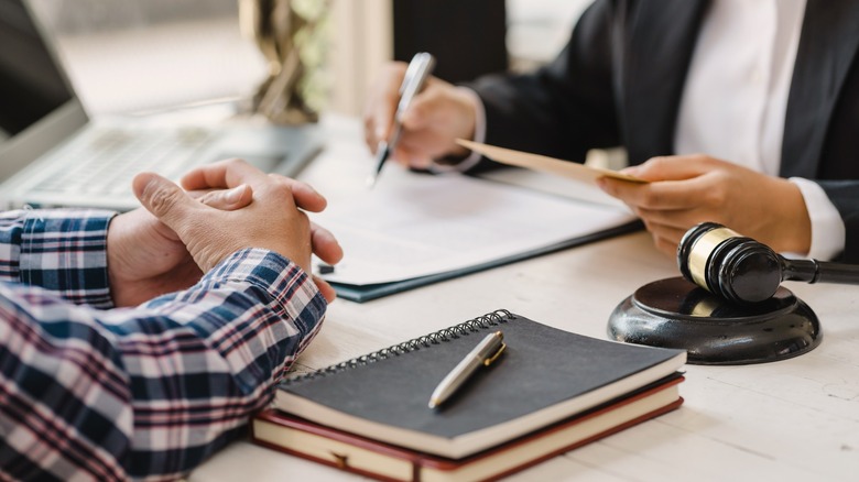 Men sitting at table with legal documents