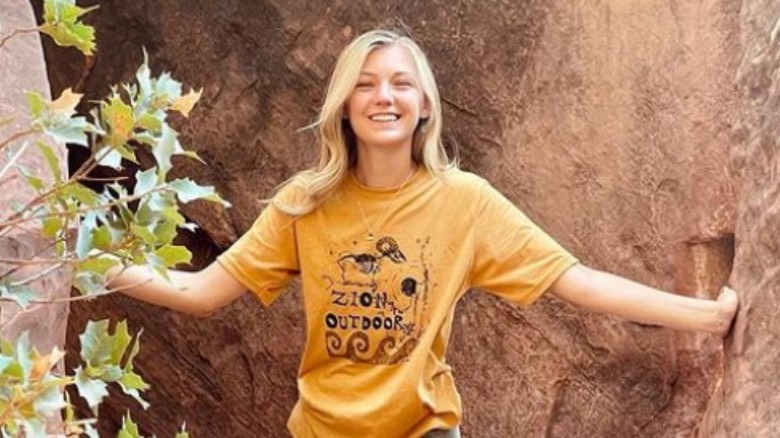 Gabby Petito smiling in front of a canyon wall