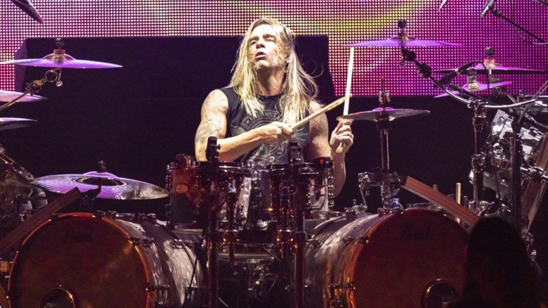 Will Hunt playing drums onstage