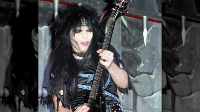 Mick Mars playing guitar onstage