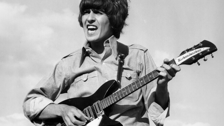 George Harrison plays a Rickenbacker guitar