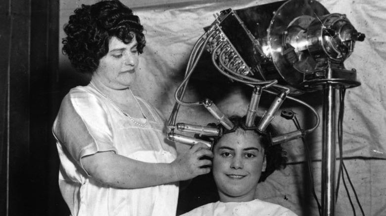 Hairdresser giving customer a perm