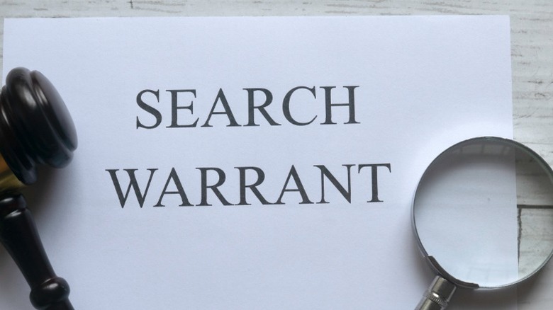 search warrant, gavel, and cuffs