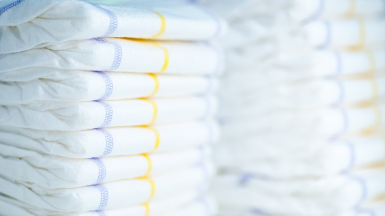 stacks of white disposable diapers