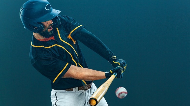 baseball player hitting ball